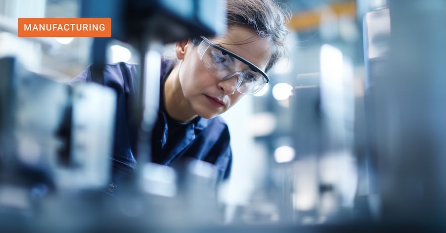 A researcher operating equipment in an industrial R&D lab, representing the domain experts empowered by operational AI in manufacturing