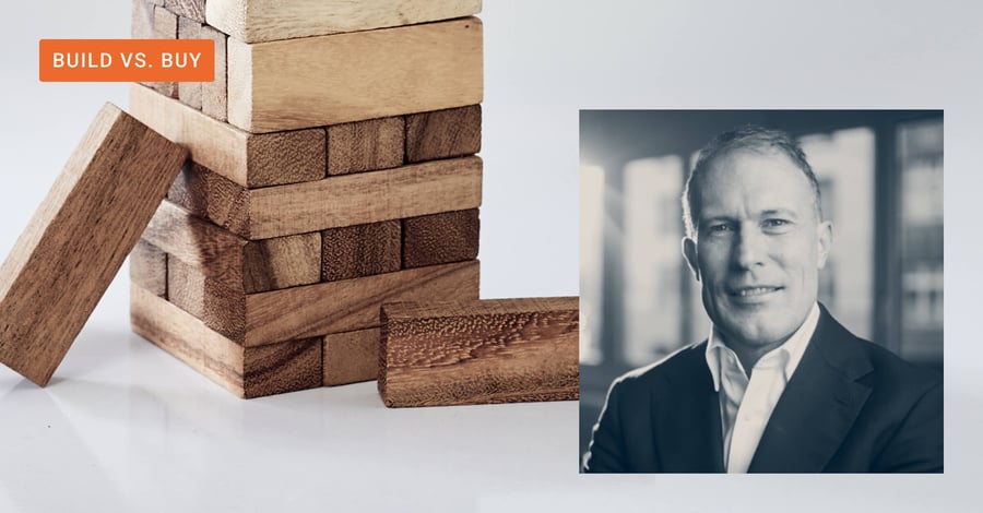 Framed image of Dorian Selz, CEO and Founder of Squirro next to Jenga blocks to represent build vs buy AI strategies.