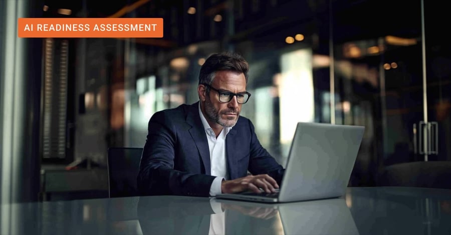 Business exec behind a laptop evaluating their organization's AI readiness. 