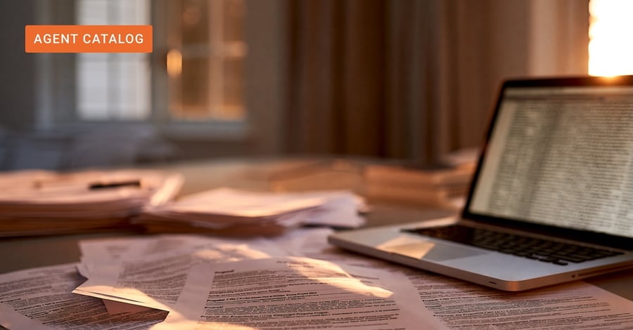Proposal pages and an open laptop spread across a desk in a corporate bid workspace at dusk.